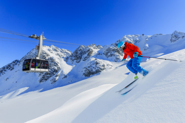 A day on the snow-covered slopes of Mont Fort, with the mountain railway in the background.