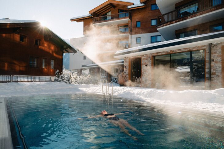 Entspannung vor und nach dem Skifahren: Gäste genießen im 70 Quadratmeter großen Außenpool der Venediger Lodge in Neukirchen am Großvenediger erholsame Stunden.